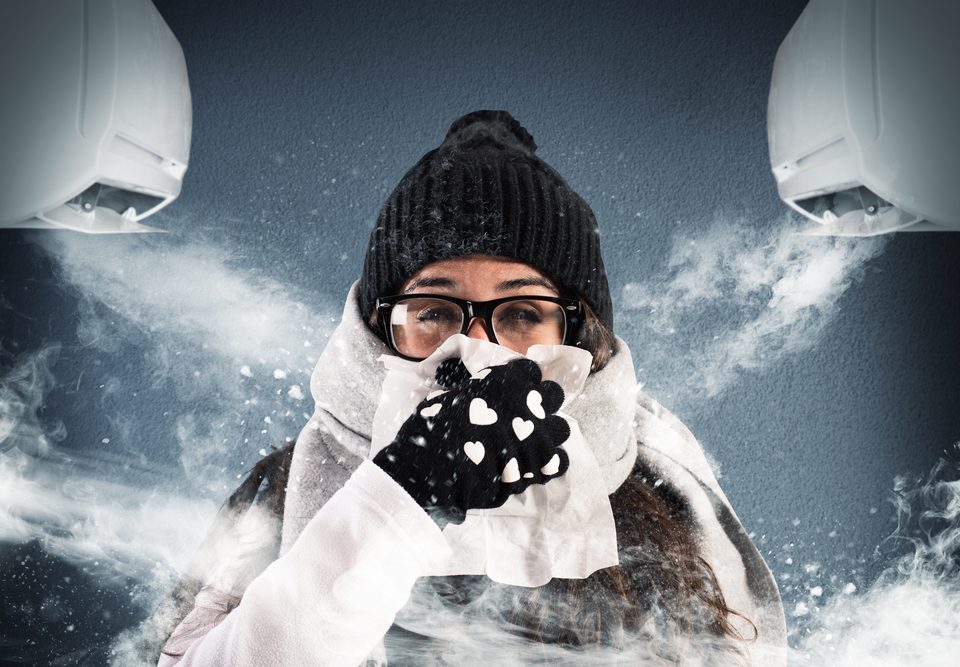 Woman wearing hat and gloves in cold room