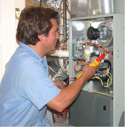 HVAC technician inspecting furnace in Pickering, Ontario